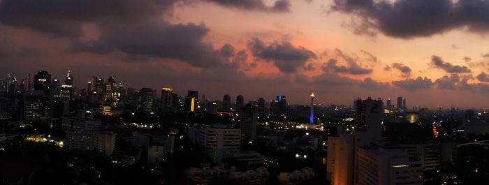 Illuminated cityscape against sky at night