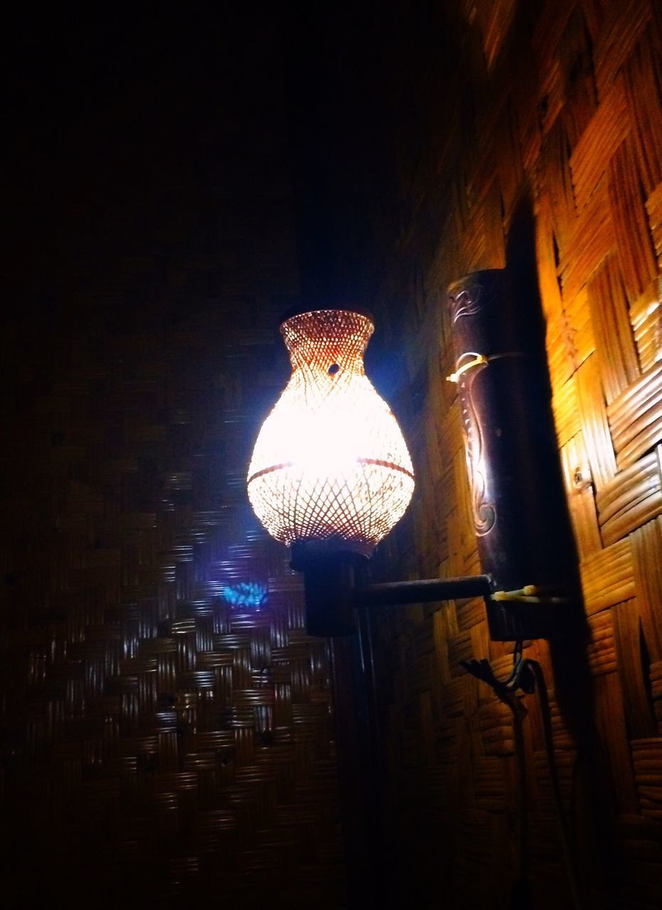LOW ANGLE VIEW OF ILLUMINATED LANTERNS HANGING ON WALL