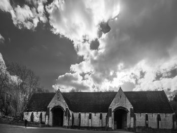 Chapel against cloudy sky
