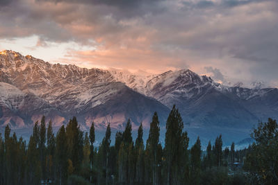 Scenic view of snowcapped mountains against sky during sunset