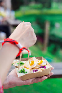 Cropped hand of woman holding gift