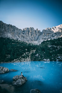 Scenic view of rocks and mountains against blue sky