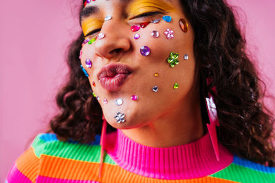 Close-up of young woman blowing bubbles