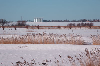 Scenic view of snow covered land against clear sky