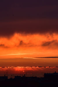 Scenic view of silhouette buildings against sky during sunset