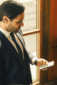 High angle view of legal professional using smart phone at office