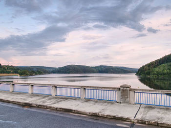 Asphalt road on dam bridge above orlik dam on the vltava river.