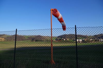 Fence on field against clear sky