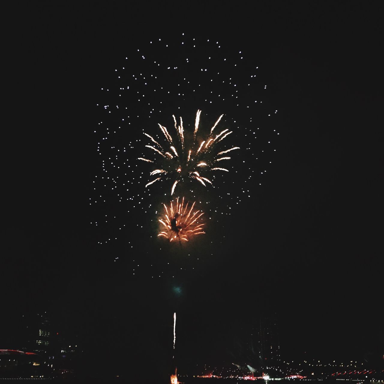 night, firework display, illuminated, exploding, celebration, long exposure, firework - man made object, motion, arts culture and entertainment, sparks, glowing, event, blurred motion, firework, low angle view, entertainment, sky, celebration event, multi colored, fire - natural phenomenon