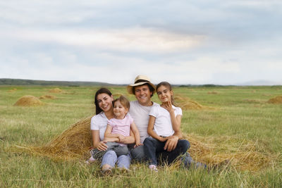 Portrait of a smiling young couple on field