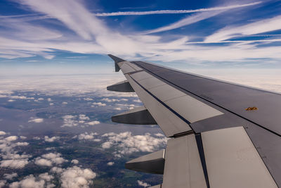 Aerial view of aircraft wing against sky
