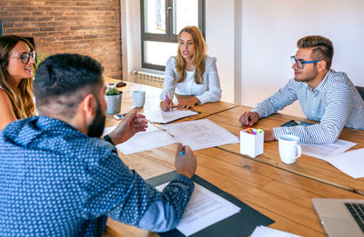 Businesspeople in a work meeting looking at construction drawings