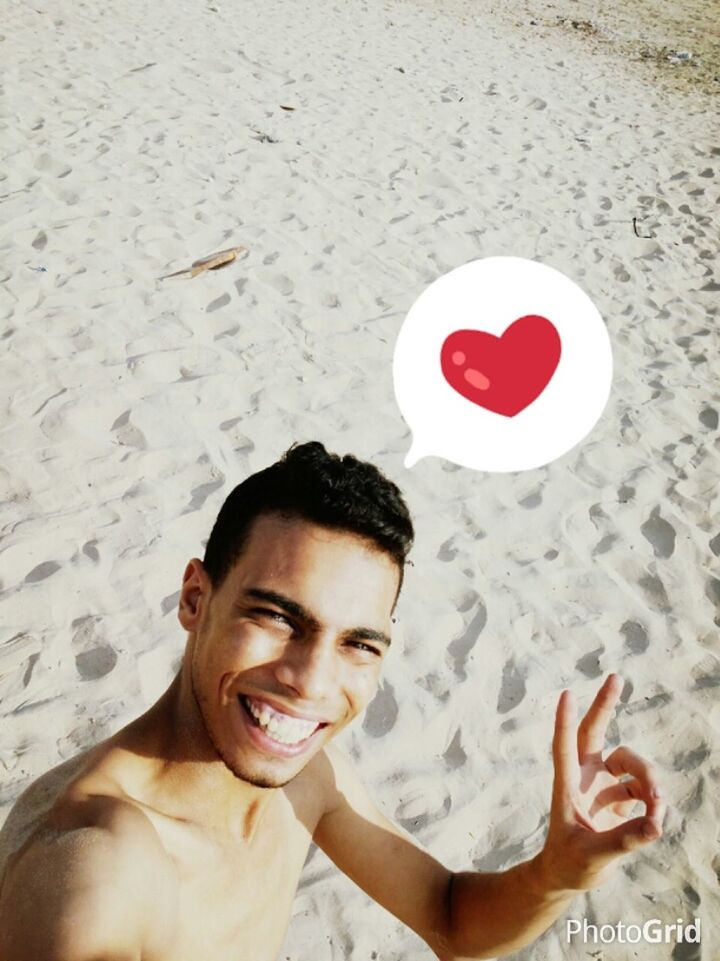 lifestyles, leisure activity, beach, person, love, sand, childhood, portrait, holding, happiness, looking at camera, smiling, shirtless, boys, communication, red, front view, headshot