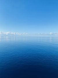 Scenic view of sea against blue sky