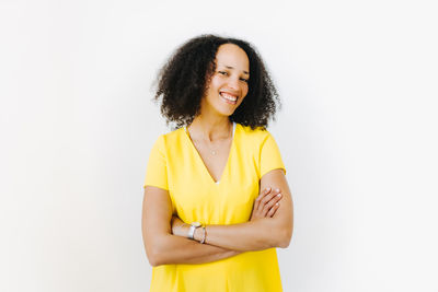 Portrait of a smiling young woman against white background