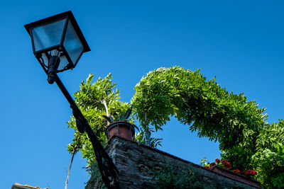 Low angle view of basketball hoop against clear blue sky