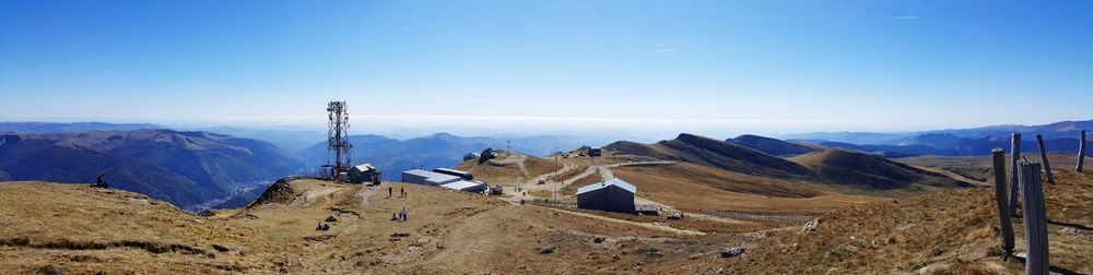 Panoramic view of landscape and mountains against blue sky