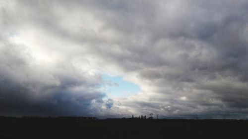 Silhouette landscape against sky