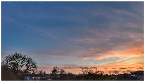 Low angle view of cloudy sky at sunset