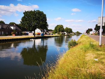 Scenic view of lake by building against sky