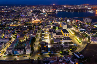 High angle view of city lit up at night