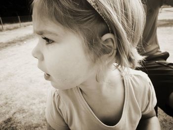 Close-up portrait of cute girl looking away