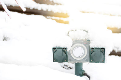 Close-up of snow covered camera