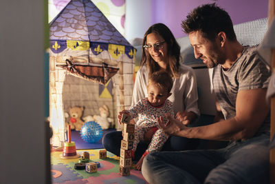 Parents playing with boy at home