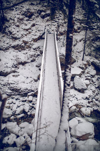 High angle view of railroad tracks on snow covered field