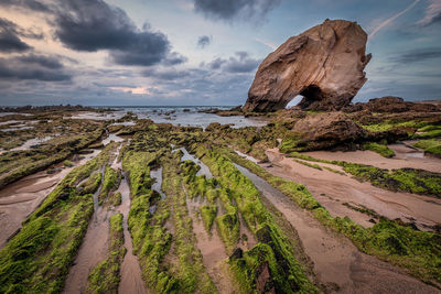 Panoramic view of rocks on beach against sky