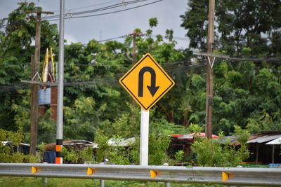 Road sign against trees