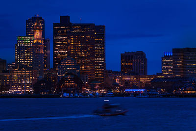 Illuminated buildings against sky at night