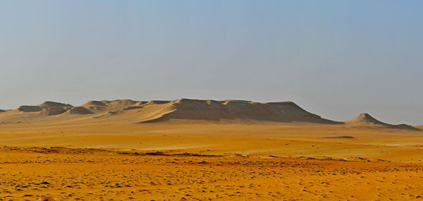 Scenic view of desert against clear sky