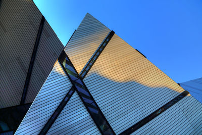 Low angle view of modern building against clear blue sky