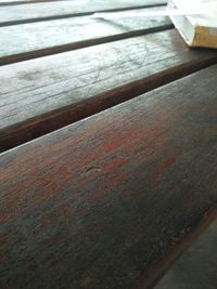 Close-up of wooden table against sea