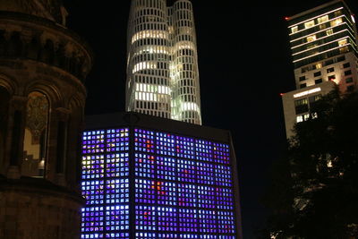 Low angle view of illuminated buildings in city at night