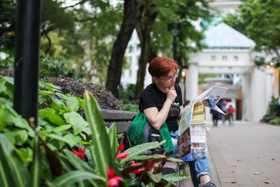 Full length of woman holding plants