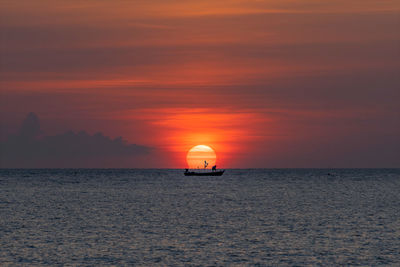 Scenic view of sea against orange sky