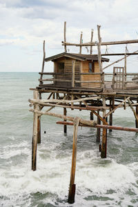 Built structure by sea against sky