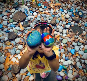 High angle view of boy playing with stones
