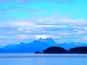 Scenic view of mountains against cloudy sky