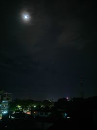 Low angle view of city lit up at night