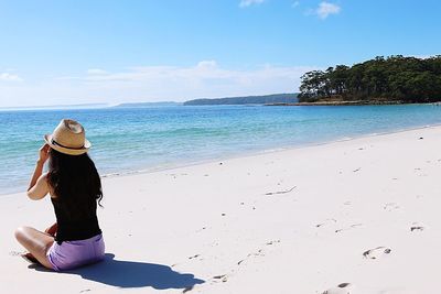 Rear view of woman looking at sea against sky