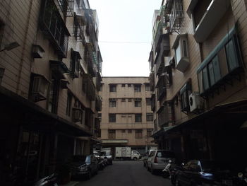 Street amidst buildings against sky in city