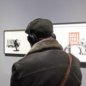 Rear view of man photographing in museum