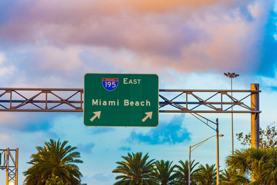 Low angle view of road sign against sky