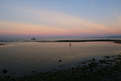 Scenic view of beach against sky during sunset