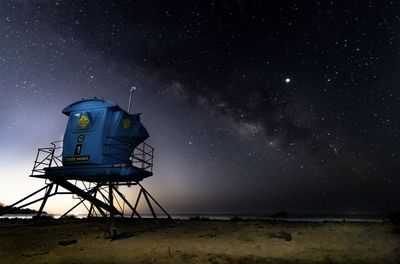 Traditional windmill against sky at night