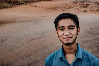 Portrait of smiling man standing outdoors