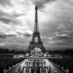 Eiffel tower against cloudy sky